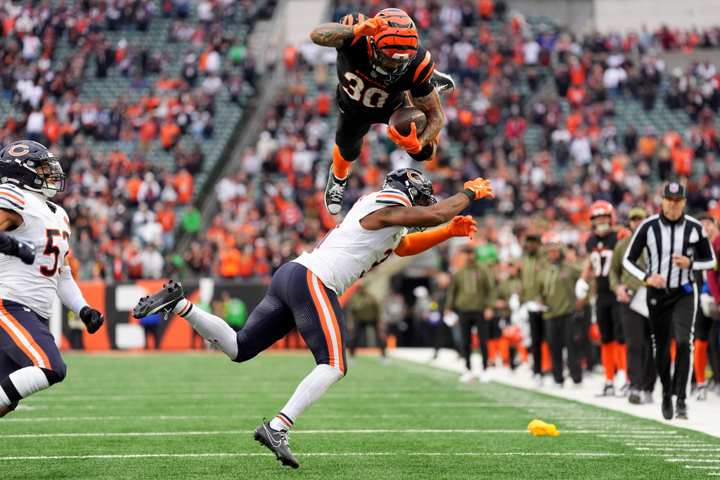 Cincinnati Bengals running back Chase Brown (30) hurdles Chicago Bears defensive back Kevin Byard III (31) on a run during an NFL football game, Nov. 2, 2025, in Cincinnati. (AP Photo/Kareem Elgazzar, File)