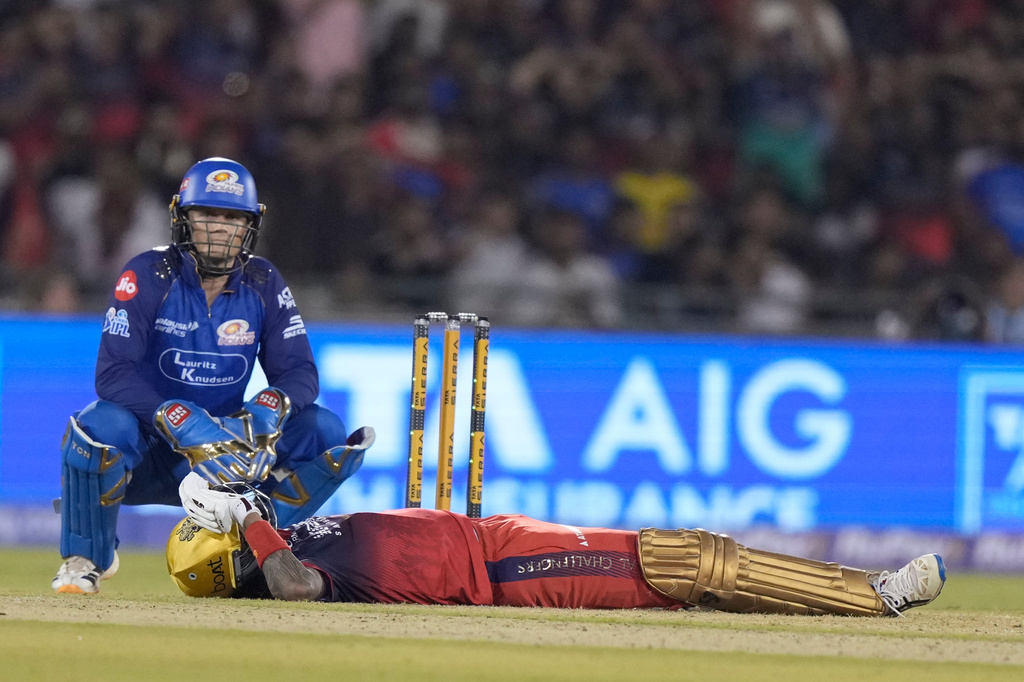 Royal Challengers Bengaluru's Krunal Pandya lies on ground after hits a six during the Indian Premier League cricket match between Royal Challengers Bengaluru and Mumbai Indians in Raipur, India, Sunday, May 10, 2026. (AP Photo/Mahesh Kumar A.)