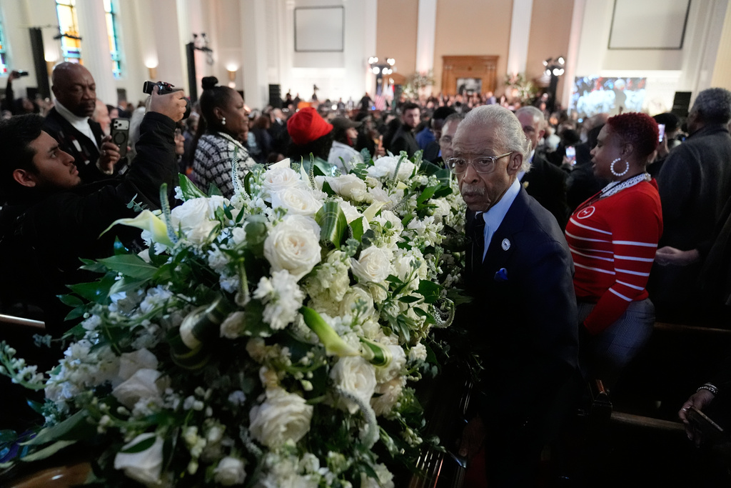 The Rev. Al Sharpton walks along the casket after the Homegoing Celebration of Life for the Rev. Jesse Jackson, Saturday, March 7, 2026, at Rainbow PUSH Coalition headquarters in Chicago. (AP Photo/Erin Hooley)