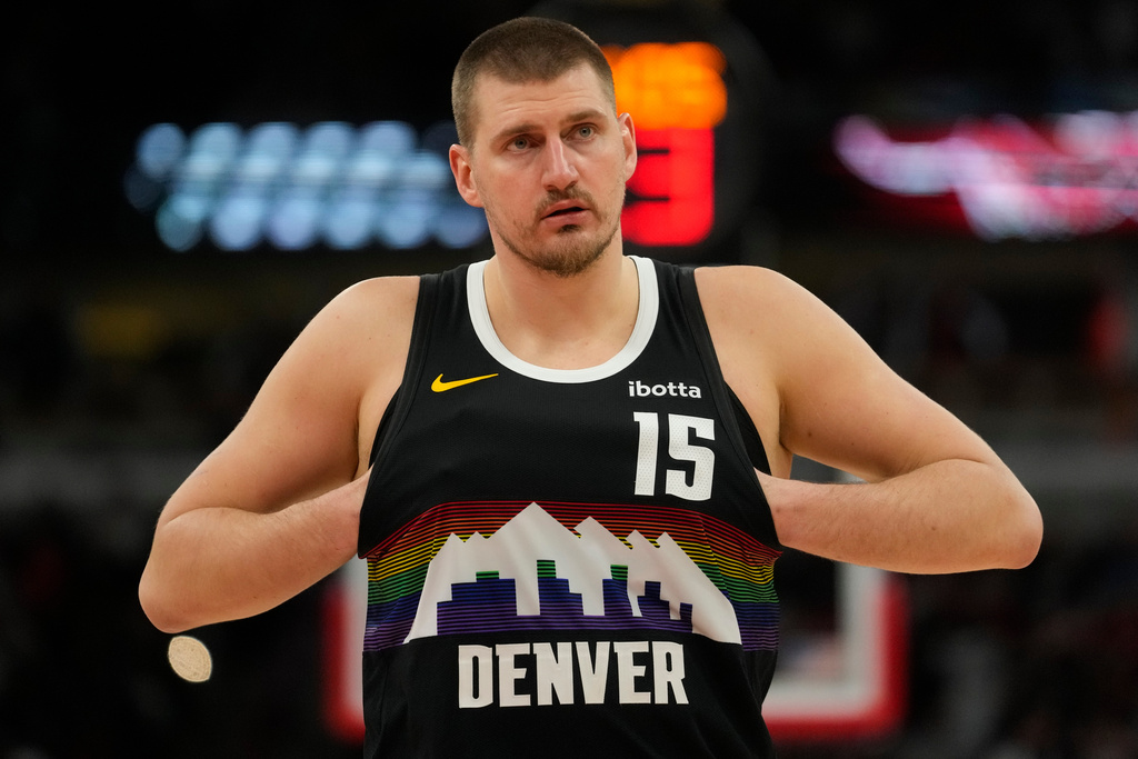 Denver Nuggets center Nikola Jokic (15) sticks his hands in his jersey during the second half of an NBA basketball game against the Chicago Bulls, Saturday, Feb. 7, 2026, in Chicago. (AP Photo/Erin Hooley)