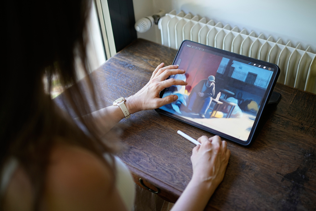 Illustrator Marina Antonova works on a drawing for her series called "Chronicles of a Heating Planet" in Beaumont-les-Valence, southern France, on Sept. 12, 2026. (AP Photo/Laurent Cipriani)