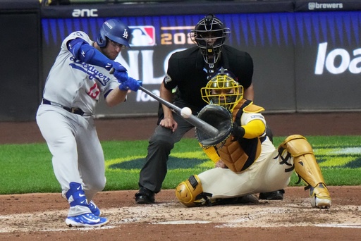 Los Angeles Dodgers' Max Muncy hits a home run during the sixth inning of Game 2 of baseball's National League Championship Series against the Milwaukee Brewers Tuesday, Oct. 14, 2025, in Milwaukee. (AP Photo/Morry Gash) Los Angeles Dodgers' Max Muncy hits a home run during the sixth inning of Game 2 of baseball's National League Championship Series against the Milwaukee Brewers Tuesday, Oct. 14, 2025, in Milwaukee. (AP Photo/Morry Gash)