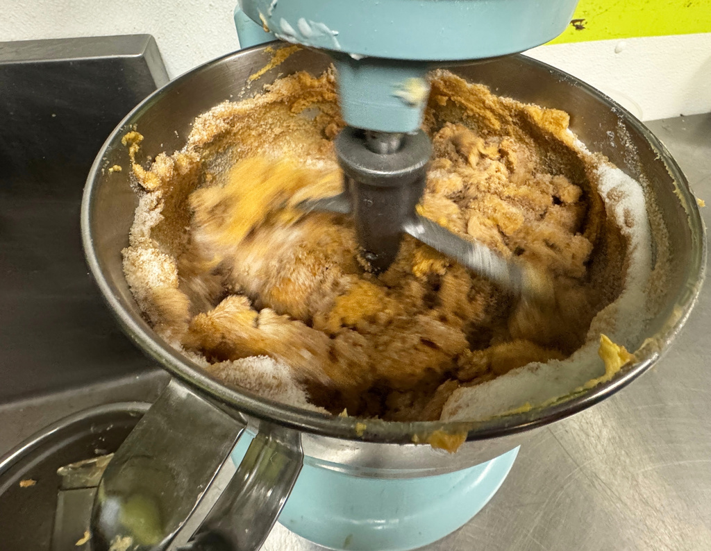 A mixer combines the ingredients for sweet potato pie on Friday, Nov. 21, 2025, in Flowood, Mississippi. (AP Photo/Sophie Bates)