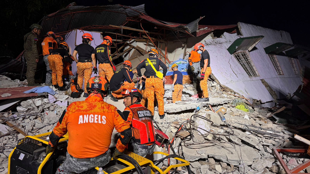 Rescuers search for survivors underneath rubble in Bogo, Philippines, Wednesday, Oct. 1, 2025. (AP Photo/Aaron Favila)