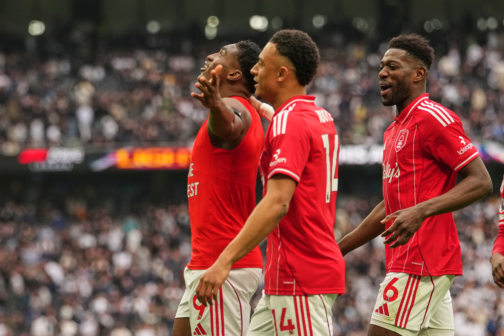 Nottingham Forest's Taiwo Awoniyi, left, celebrates with teammates after scoring his side's third goal during the English Premier League soccer match between Tottenham Hotspur and Nottingham Forest in London, Sunday, March 22, 2026. (AP Photo/Dave Shopland)