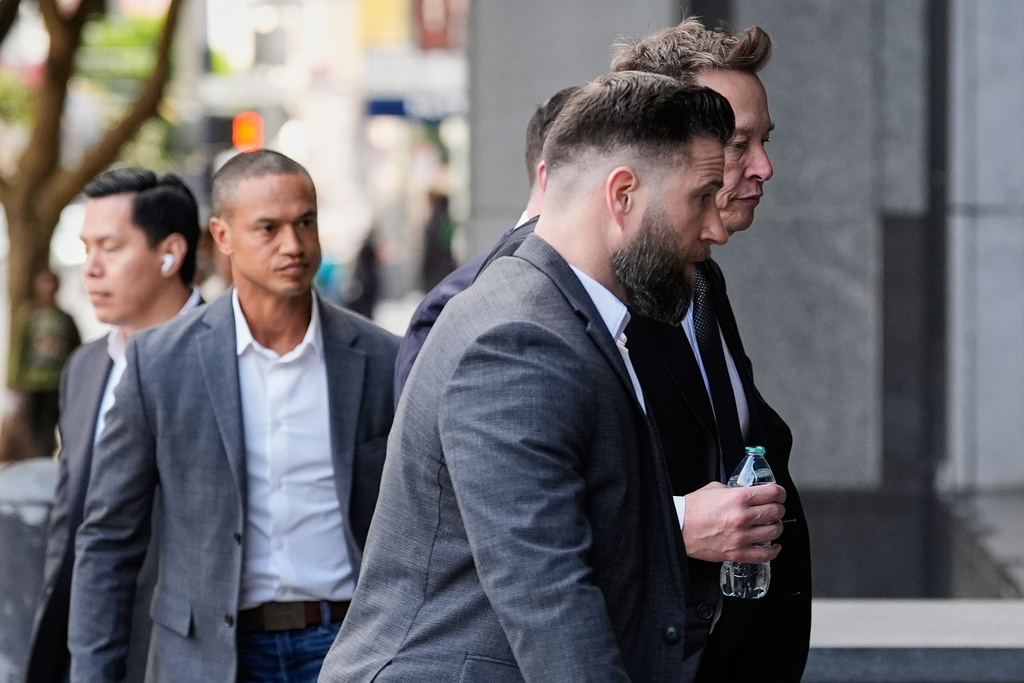 Elon Musk, right, arrives for a Twitter shareholder trial at the U.S. District Court for the Northern District of California in San Francisco, on Wednesday, March 4, 2026. (AP Photo/Godofredo A. Vásquez)
