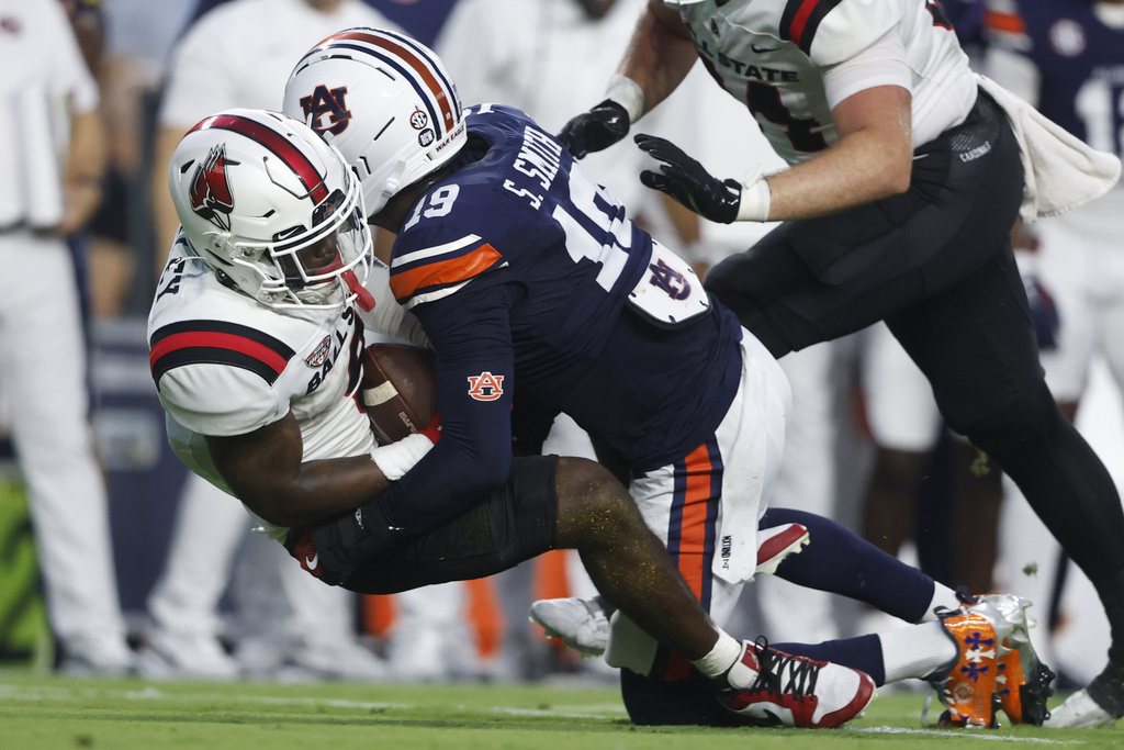Ball State running back Qua Ashley (9) is tackled for a loss by Auburn safety Sylvester Smith (19) during the first half of an NCAA college football game, Saturday, Sept. 6, 2025, in Auburn, Ala. (AP Photo/Butch Dill)