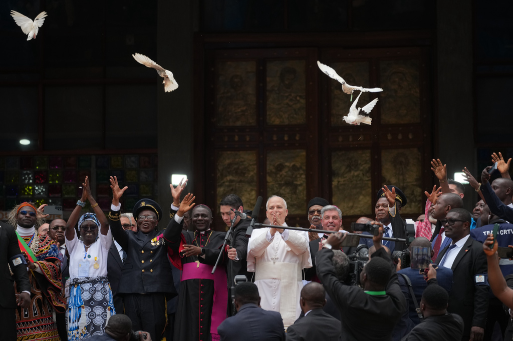 Pope Leo XIV, with the Archbishop of Bamenda, Andrew Nkea Fuanya, left, frees a white dove at the end of a meeting for peace at Saint Joseph's Cathedral in Bamenda, Cameroon, with the local community Thursday, April 16, 2026, on the fourth day of his 11-day pastoral visit to Africa. (AP Photo/Andrew Medichini)