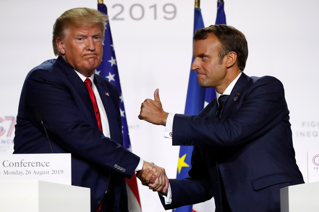 FILE - In this Aug. 26, 2019, file photo, French President Emmanuel Macron and U.S President Donald Trump shake hands during the final press conference during the G7 summit in Biarritz, southwestern France. (AP Photo/Francois Mori, File)