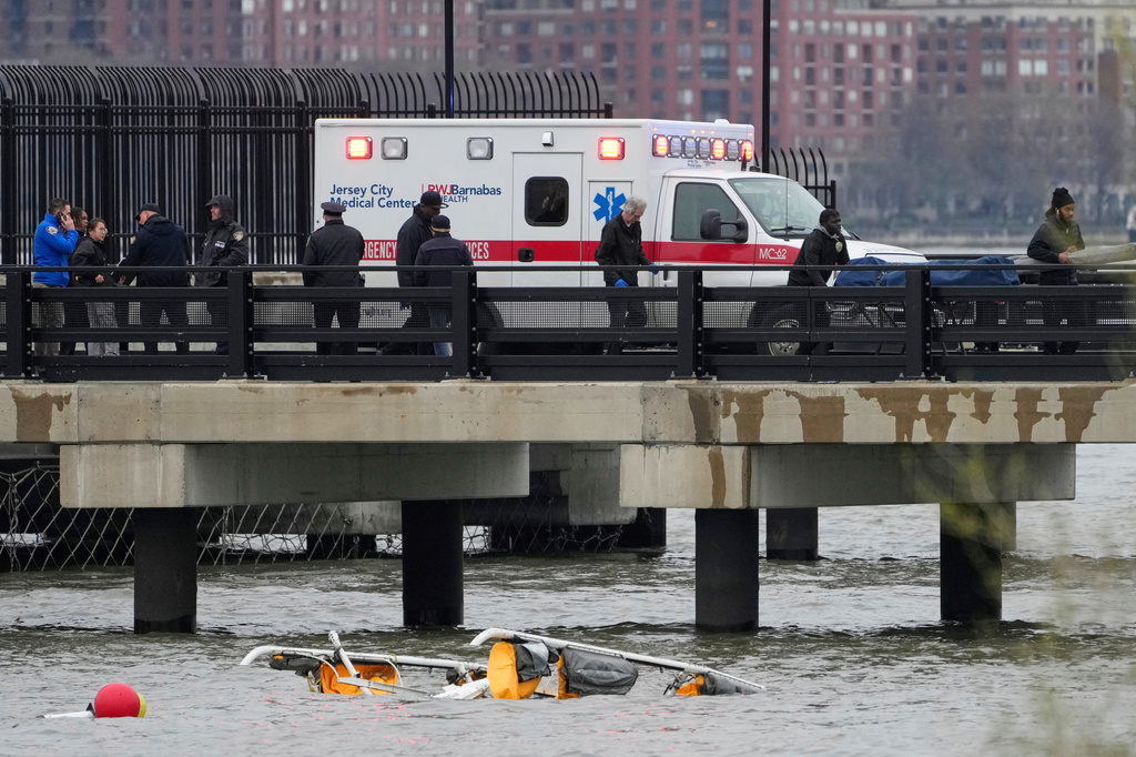 FILE - Emergency personnel respond to a helicopter crash on the Hudson River, April 10, 2025, in Jersey City, N.J. (AP Photo/Seth Wenig, File)