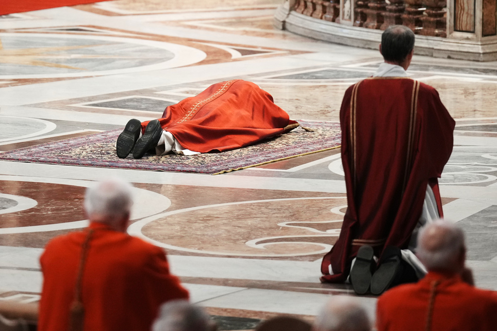 Pope Leo XIV lies prostrate at the Celebration of the Passion of the Lord in St. Peter's Basilica at the Vatican on Catholic Good Friday, Friday, April 3, 2026 (AP Photo/Andrew Medichini)