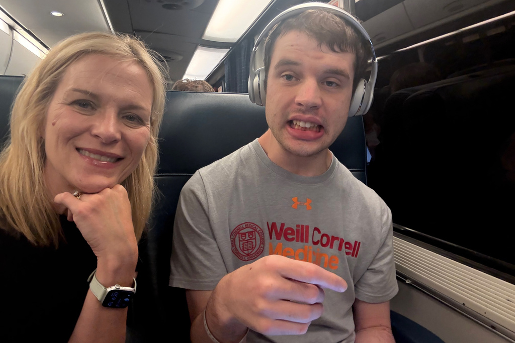 This photo provided by Judith Ursitti, cofounder and president of the Profound Autism Alliance, shows her with her son, Jack, who is autistic, in New York on Sunday, Aug. 3, 2025. (Judith Ursitti via AP)