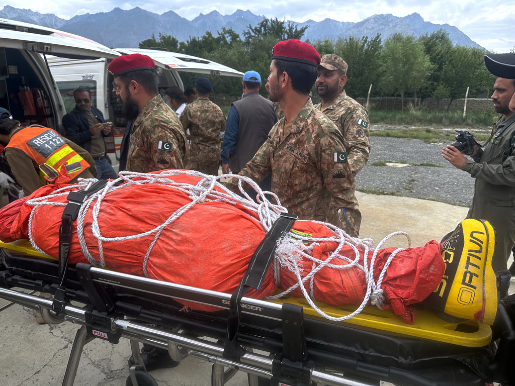 Pakistani army soldiers prepare to load into an ambulance, the body of renowned British-Nepali mountaineer Nirmal Purja, that was recovered from Broad Peak nearly a week after an avalanche swept away a 10-member international expedition, upon arrival at military base in Skardu, in northern Pakistan, Thursday, Aug 6, 2026. (AP Photo/ M.H. Balti)