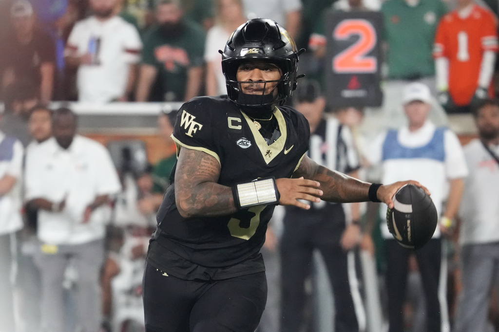 Wake Forest quarterback Gio Lopez looks to pass the ball against Miami during the first half of an NCAA college football game in Winston-Salem, N.C., Friday, Sept. 18, 2026. (AP Photo/Chuck Burton)