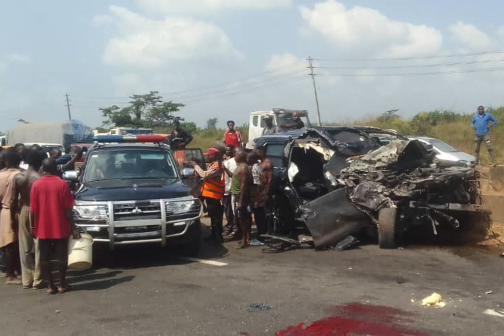 In this photo provided by the Federal Road Safety Corps, people gather at the accident scene of British boxer Anthony Joshua in Lagos, Nigeria, on Monday, Dec. 29, 2025. (Federal Road Safety Corps via AP)