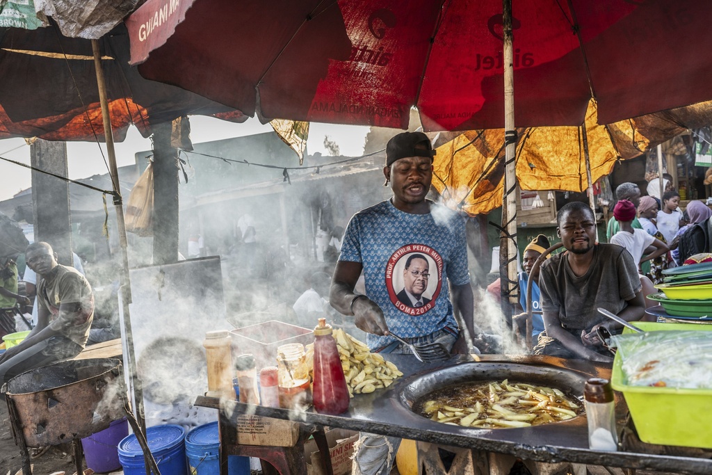 A street vendor wears a shirt with a picture of presidential candidate Peter Mutharika in Zomba, Malawi, Wednesday, Sept. 10, 2025. (AP Photo/Thoko Chikondi)