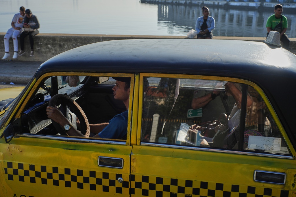 A taxi drives customers in Havana, Monday, Jan. 26, 2026. (AP Photo/Ramon Espinosa)
