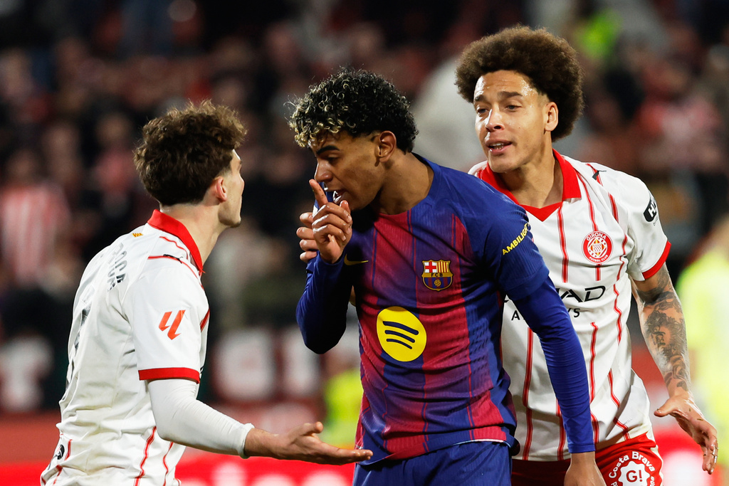 Barcelona's Lamine Yamal argues with Girona's Joel Roca during a Spanish La Liga soccer match between Girona and Barcelona in Girona, Spain, Monday, Feb. 16, 2026. (AP Photo/Joan Monfort)
