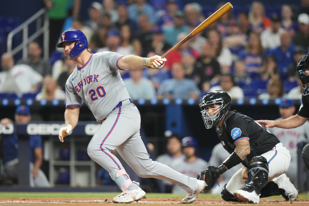 New York Mets' Pete Alonso (20) follows through on a double during the first inning of a baseball game against the Miami Marlins, Friday, Sept. 26, 2025, in Miami. (AP Photo/Lynne Sladky)