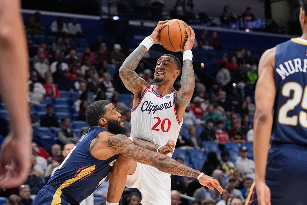Los Angeles Clippers forward John Collins (20) goes to the basket against New Orleans Pelicans guard Saddiq Bey in the first half of an NBA basketball game, Wednesday, March 18, 2026, in New Orleans. (AP Photo/Gerald Herbert)