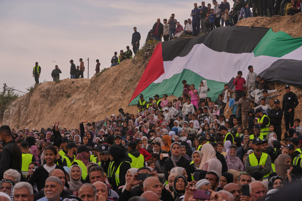 Palestinians watch and celebrate a mass wedding ceremony in Deir al-Balah, central Gaza Strip, Friday, April 24, 2026. (AP Photo/Abdel Kareem Hana)