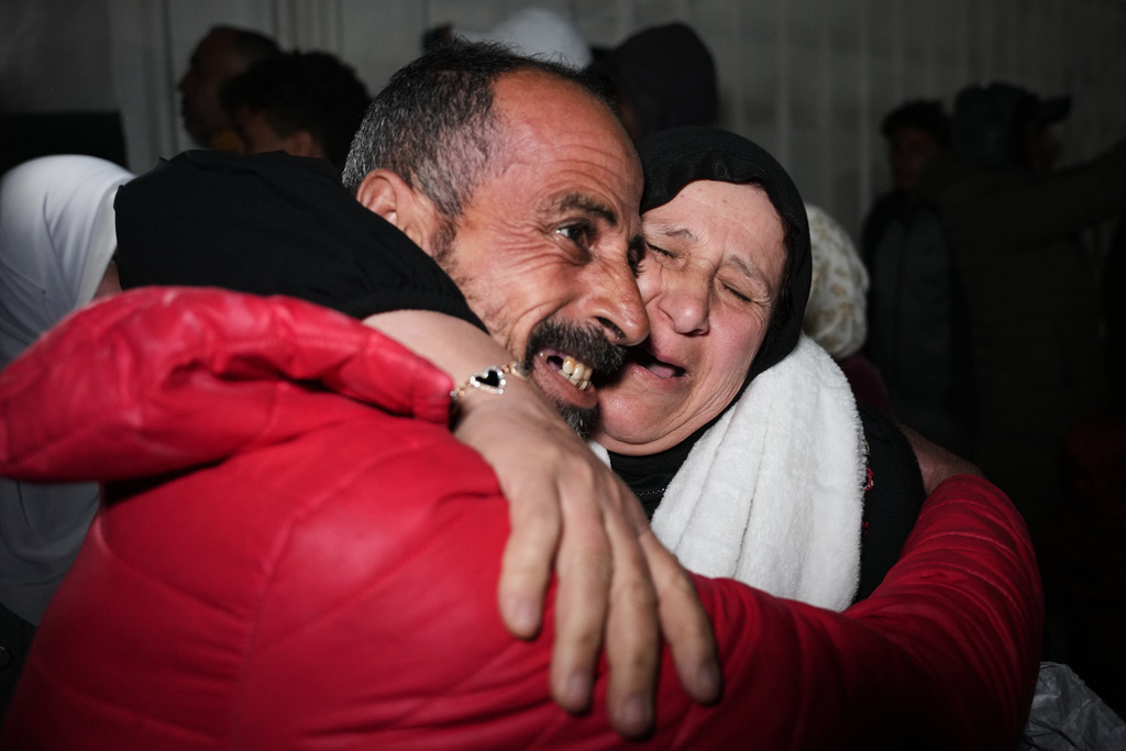 Ayada Al-Sheikh is welcomed by his sister, Nisreen, upon his arrival in Khan Younis in the southern Gaza Strip after returning to Gaza following the long-awaited reopening of the Rafah border crossing, early Thursday, Feb. 5, 2026. (AP Photo/Abdel Kareem Hana)