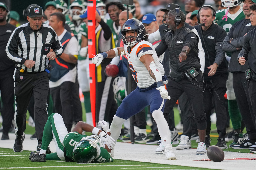 Denver Broncos safety Talanoa Hufanga (9) reacts after blocking a pass to New York Jets wide receiver Garrett Wilson (5) in the second half of an NFL football game between the Denver Broncos and the New York Jets, Sunday, Oct. 12, 2025, in London. (AP Photo/Kin Cheung)