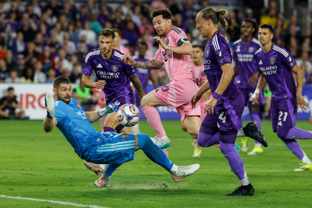 Inter Miami CF forward Lionel Messi, center, goal attempt is stop by Orlando City SC goalkeeper Maxime Crépeau, left, during the first half of an MLS soccer match, Sunday, March 1, 2026, in Orlando, Fla. (AP Photo/Kevin Kolczynski)