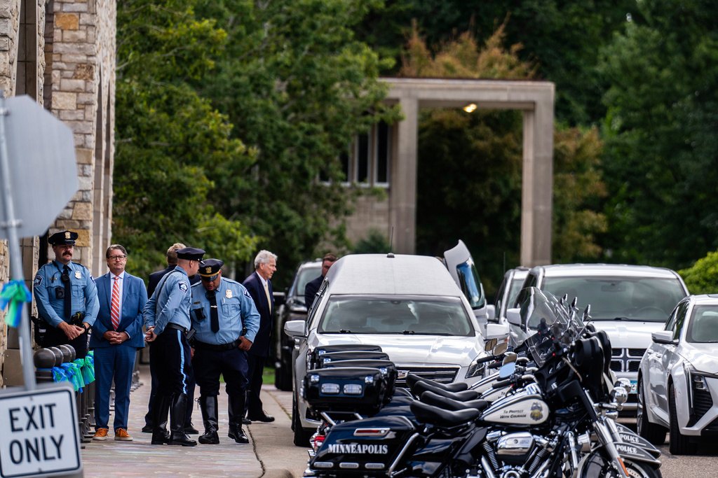 The hearse for the funeral of 8-year-old Fletcher Merkel, who died in a school church shooting, arrives at Mt. Olivet Lutheran Church, in Minneapolis, Sunday, Sept. 7, 2025. (Richard Tsong-Taatarii/Star Tribune via AP)