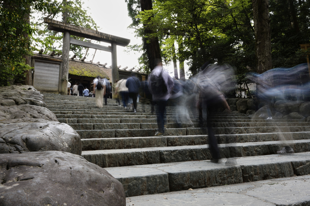 Visitors walk upstairs to visit the main palace at Kotaijingu, also known as Naiku, or the inner sanctuary, of the Jingu shrine complex in Ise, central Japan, Thursday, May 1, 2025. (AP Photo/Hiro Komae)