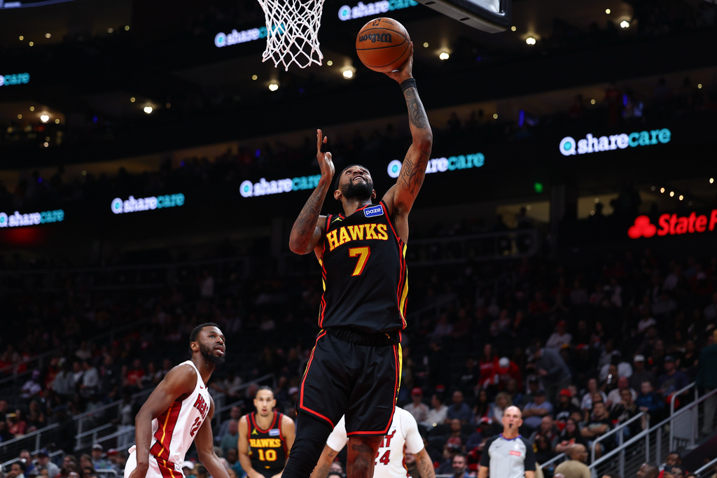 Atlanta Hawks guard Nickeil Alexander-Walker (7) shoots against Miami Heat forward Andrew Wiggins, left, during the first half of an NBA basketball game, Friday, Feb. 20, 2026, in Atlanta. (AP Photo/Colin Hubbard)