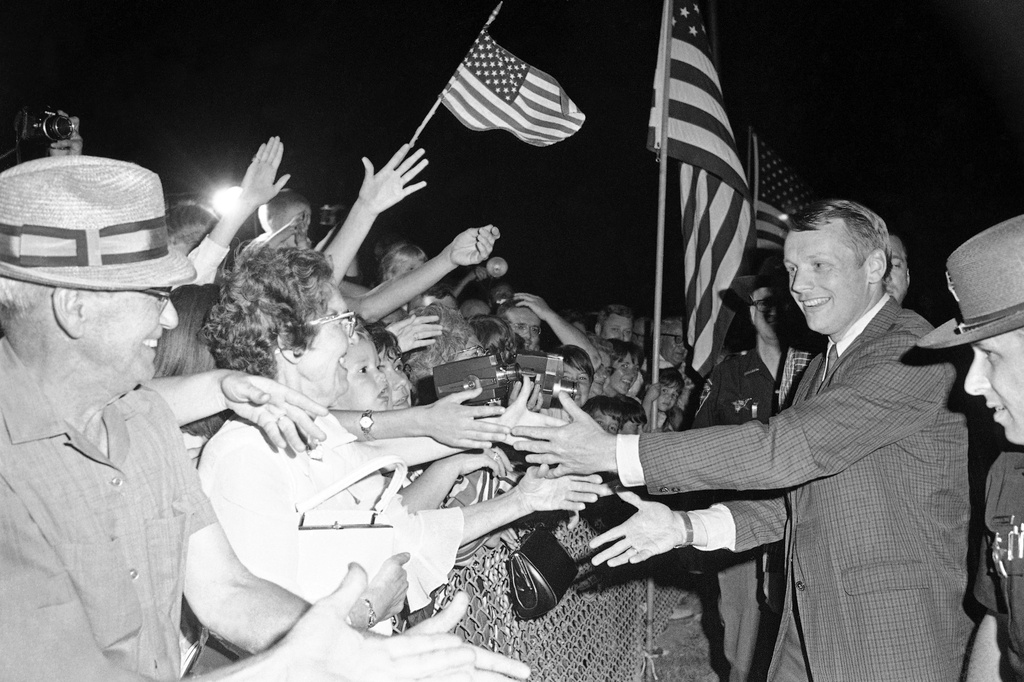 FILE - Astronaut Neil Armstrong, the first man to walk on the moon, shakes hands with the crowd at the Allen County Airport, Sept. 5, 1969, in Lima, Ohio. (AP Photo/CEK, File)