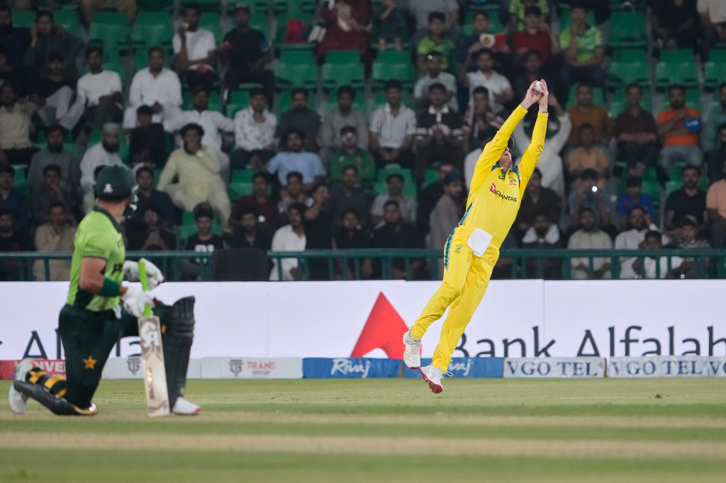 Australia's Adam Zampa, right, jumps to take a catch to dismiss Pakistan's Sahibzada Farhan, left, during the second one-day international cricket match between Pakistan and Australia, in Lahore, Pakistan, Tuesday, June 2, 2026. (AP Photo/K.M. Chaudary)