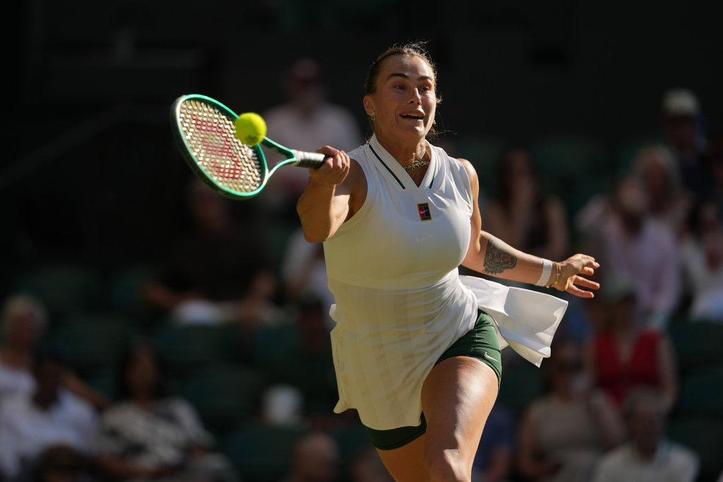 Aryna Sabalenka of Belarus returns the ball to Jelena Ostapenko of Latvia in their third round women's singles match at the Wimbledon Tennis Championships in London, Friday, July 3, 2026. (AP Photo/Kin Cheung)