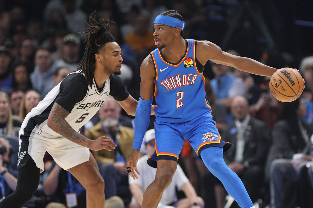 Oklahoma City Thunder guard Shai Gilgeous-Alexander (2) looks for an outlet against San Antonio Spurs guard Stephon Castle (5) during the first half of an NBA basketball game, Tuesday, Jan. 13, 2026, in Oklahoma City. (AP Photo/Nate Billings)