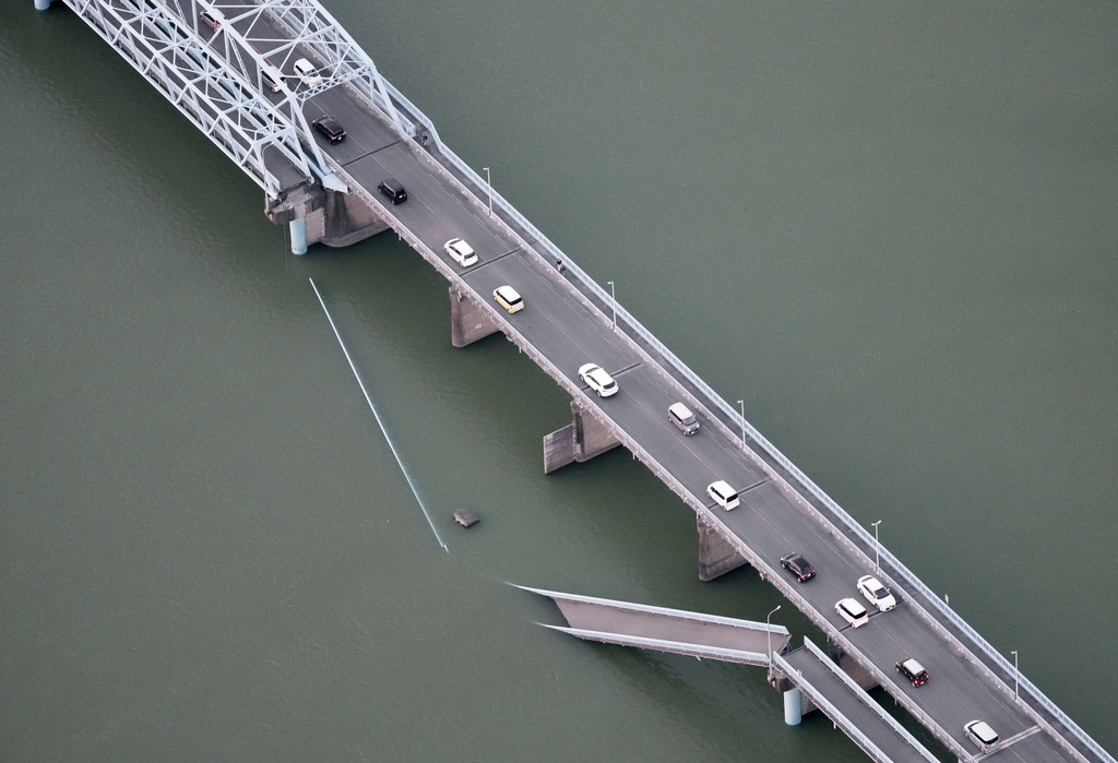 This aerial image shows a partially collapsed bridge after the earthquake in Yatsushiro, Kumamoto Prefecture, on Tuesday, July 28, 2026. (Kyodo News via AP)