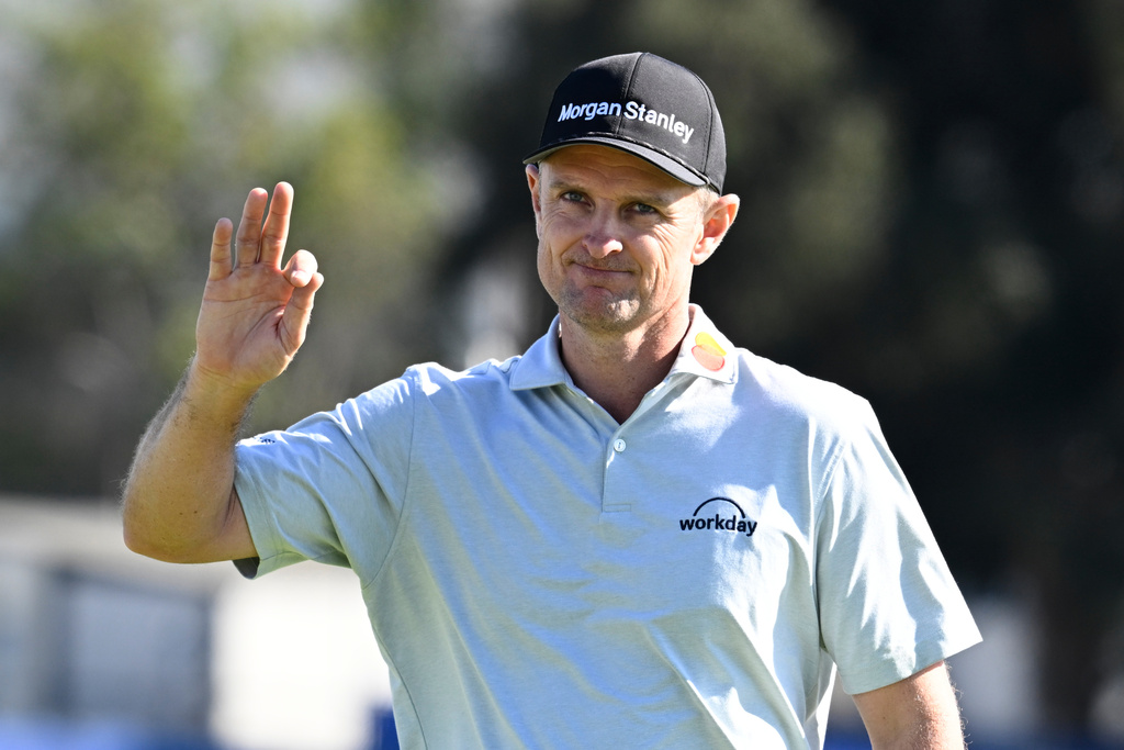 Justin Rose, of England, waves to the gallery on the 15th green of the South Course at Torrey Pines during the final round of the Farmers Insurance Open golf tournament Sunday, Feb. 1, 2026, in San Diego. (AP Photo/Denis Poroy)