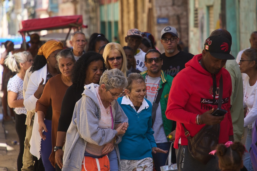 People wait in line to enter a government office in Havana, Cuba, Wednesday, Feb. 11, 2026. (AP Photo/Ramon Espinosa)