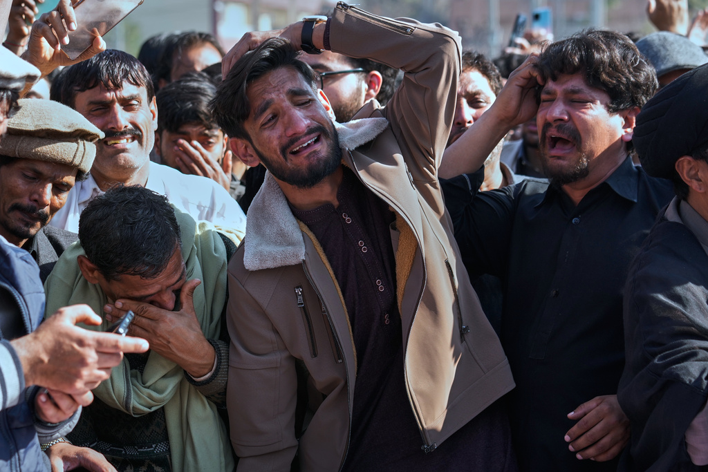 People mourn over coffins of their relatives, who were killed in Friday's suicide bombing inside a Shiite mosque, in Islamabad, Pakistan, Saturday, Feb. 7, 2026. (AP Photo/Anjum Naveed)