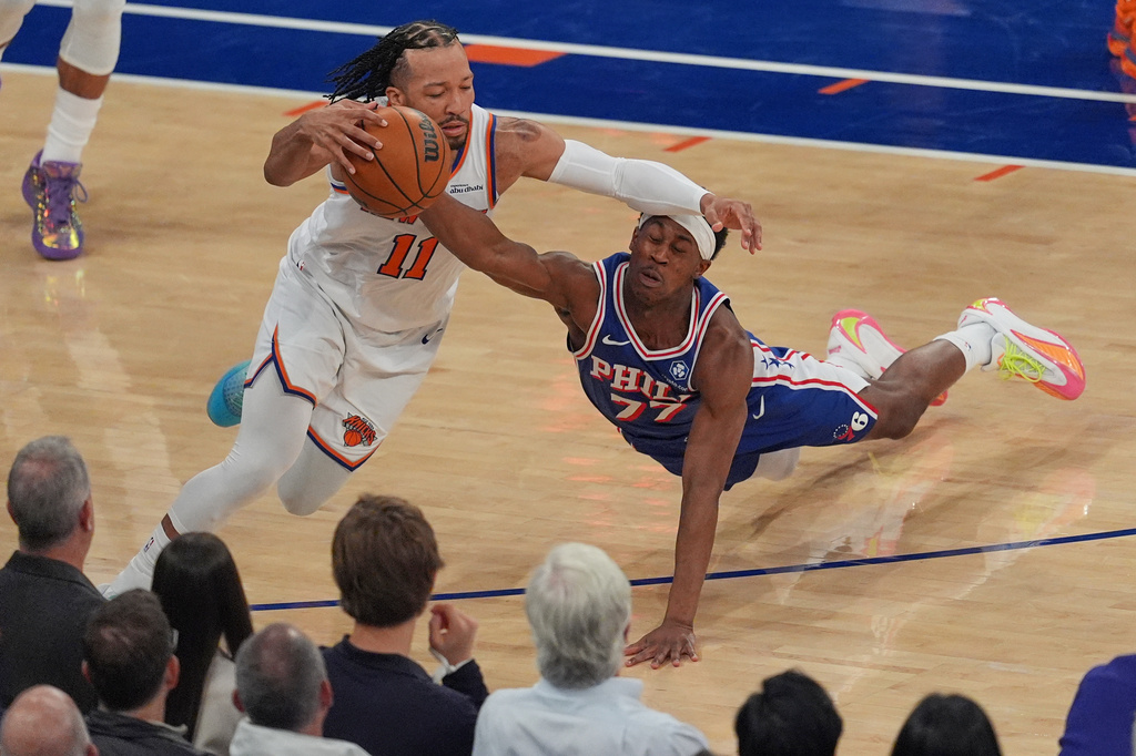 Philadelphia 76ers' Vj Edgecombe, right, fouls New York Knicks' Jalen Brunson during the first half of Game 1 in a second-round NBA basketball playoffs series Monday, May 4, 2026, in New York. (AP Photo/Seth Wenig)
