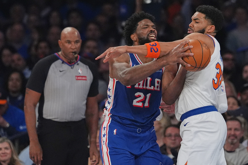 New York Knicks' Karl-Anthony Towns, right, fouls Philadelphia 76ers' Joel Embiid during the first half of Game 1 in a second-round NBA basketball playoffs series Monday, May 4, 2026, in New York. (AP Photo/Seth Wenig)