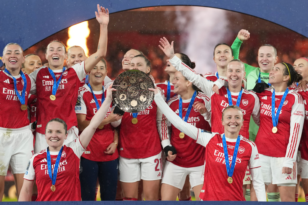 FILE - Arsenal's team captains Kin Little, left, and Leah Williamson, right, lift the trophy after winning the Women's Champions Cup final soccer match between Arsenal FC and SC Corinthians in London, Sunday, Feb. 1, 2026. (AP Photo/Alastair Grant, File)