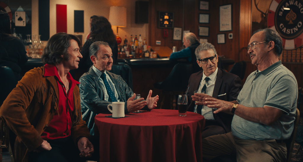 This image released by Focus Features shows Hugh Jackman, from left, Fisher Stevens, Michael Imperioli and Jim Belushi in a scene from "Song Sung Blue." (Focus Features via AP)