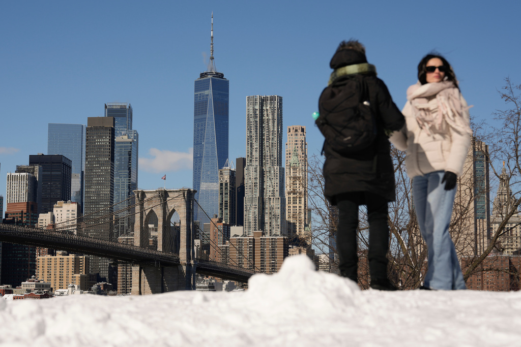 Women take in the skyline view of Manhattan from Brooklyn Bridge Park, Tuesday, Feb. 24, 2026, in the Brooklyn borough of New York. (AP Photo/Yuki Iwamura)