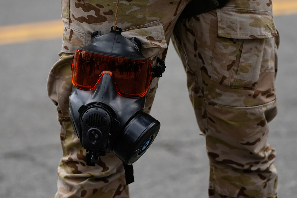 FILE - A gas mask and goggles are seen attached to a Customs and Border Protection officer's leg outside a U.S. Immigration and Customs Enforcement facility, Oct. 4, 2025, in Portland, Ore. (AP Photo/Jenny Kane, File)