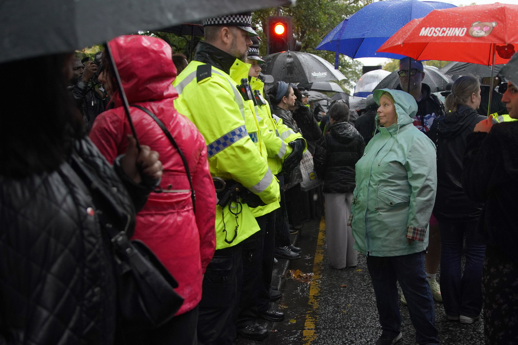 A woman speaks to police as she attends a vigil for the victims of the attack at Heaton Park Hebrew Congregation synagogue, in Crumpsall, Manchester, England, Friday, Oct. 3, 2025. (AP Photo/Ian Hodgson)
