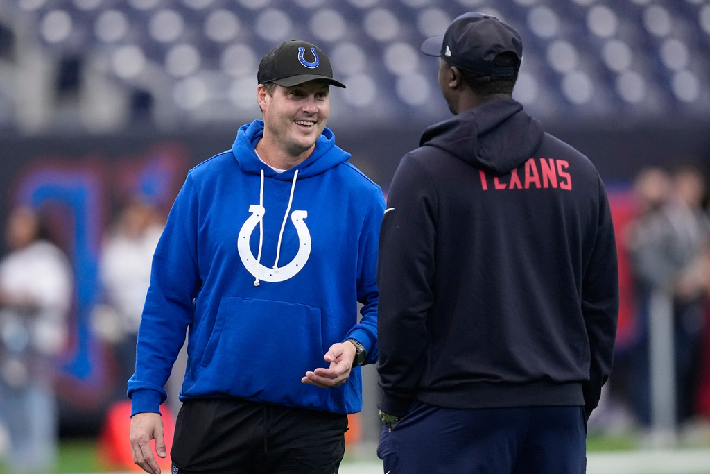 Indianapolis Colts quarterback Philip Rivers, left, visits before an NFL football game against the Houston Texans in Houston, Sunday, Jan. 4, 2026. (AP Photo/David J. Phillip)