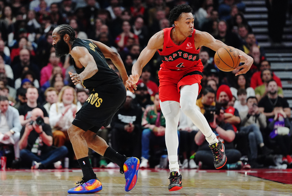Toronto Raptors' Scottie Barnes (4) drives past Cleveland Cavaliers' James Harden (1) during the first half of Game 6 in the first round of an NBA basketball playoffs series in Toronto on Friday, May 1, 2026. (Frank Gunn/The Canadian Press via AP)