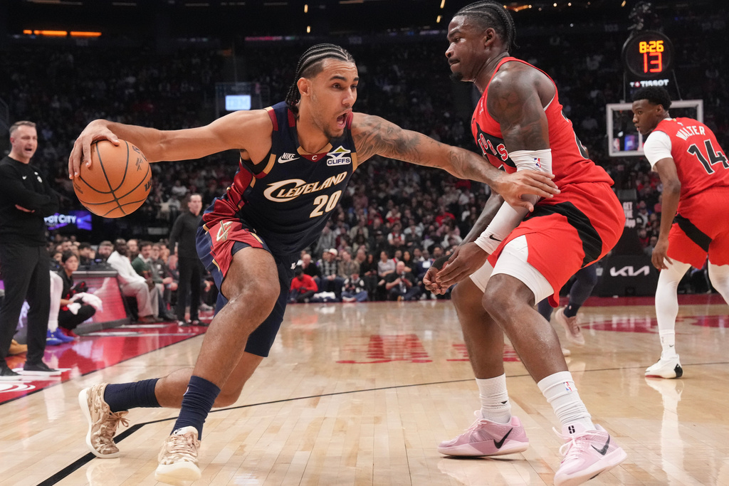 Cleveland Cavaliers guard Jaylon Tyson drives at Toronto Raptors guard Jamal Shead (23) during the first half of an NBA basketball game in Toronto on Monday Nov. 24, 2025. (Chris Young/The Canadian Press via AP)