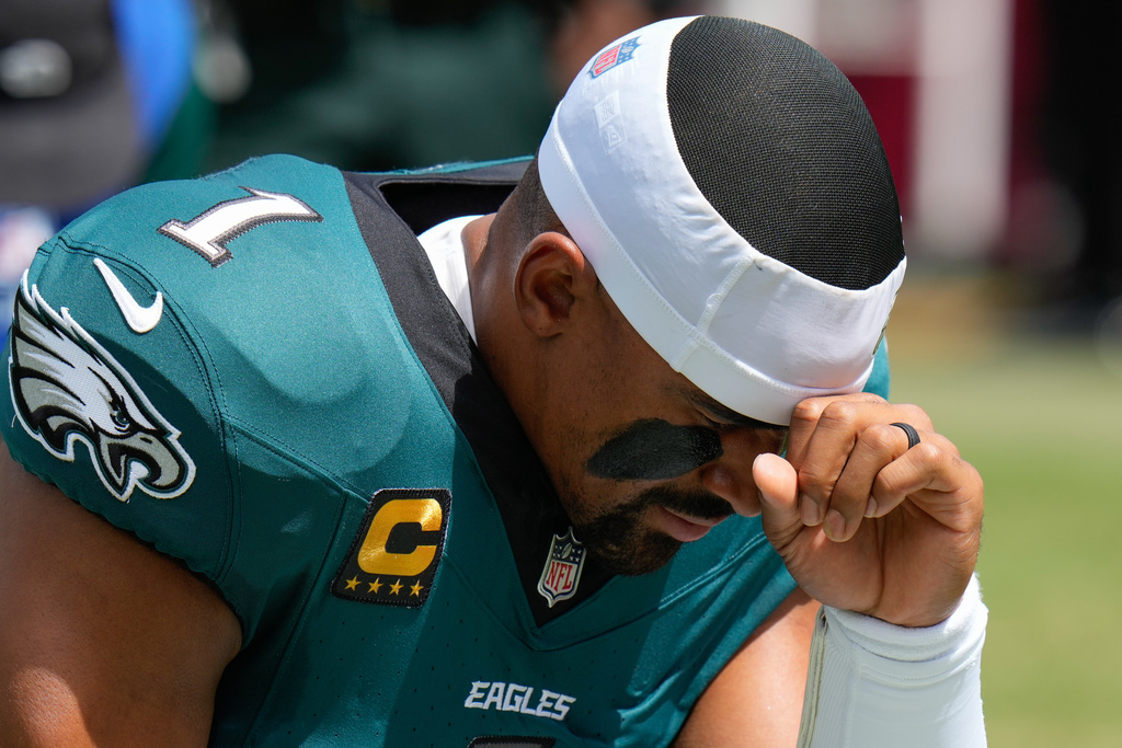 Philadelphia Eagles quarterback Jalen Hurts (1) kneels before an NFL football game against the Tampa Bay Buccaneers, Sunday, Sept. 28, 2025, in Tampa, Fla. (AP Photo/Chris O'Meara)